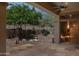 Inviting covered patio with stone flooring, landscaping and a dry sauna at 1958 W Legends Way, Anthem, AZ 85086