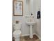 Clean powder room with stylish fixtures, decorative mirror and towel with monogrammed letter at 1958 W Legends Way, Anthem, AZ 85086