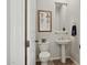 Cozy powder room with stylish fixtures, decorative mirror, and patterned wall art at 1958 W Legends Way, Anthem, AZ 85086