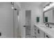 Modern bathroom featuring a sleek vanity, a tiled shower and modern patterned tile flooring at 2018 E Balboa Dr, Tempe, AZ 85282