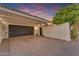 Exterior view of the garage with a paved driveway and a small garden area on the side at 2018 E Balboa Dr, Tempe, AZ 85282