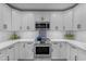 A stylish kitchen with white cabinets, stainless steel appliances, and decorative tile detail at 2018 E Balboa Dr, Tempe, AZ 85282