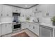 A modern kitchen features white cabinetry, stainless steel appliances, and stylish subway tile backsplash at 2018 E Balboa Dr, Tempe, AZ 85282