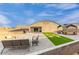 Scenic backyard area with covered seating, brick pavers, and plenty of space for outdoor activities at 203 S 190Th Ave, Buckeye, AZ 85326