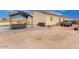 Large backyard, with a covered seating area, brick pavers, and additional area for outdoor activities at 203 S 190Th Ave, Buckeye, AZ 85326