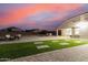 Spacious backyard with artificial turf, brick pavers, an outdoor kitchen, and seating; great for Gathering gatherings at 203 S 190Th Ave, Buckeye, AZ 85326