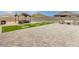 Relaxing backyard area with a covered seating area, artificial turf, and brick pavers at 203 S 190Th Ave, Buckeye, AZ 85326