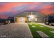 Beautiful backyard featuring a green artificial turf design and brick pavers, perfect for outdoor entertaining at 203 S 190Th Ave, Buckeye, AZ 85326