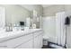 Bathroom featuring a double sink vanity with white cabinets and tub/shower combination with curtain at 203 S 190Th Ave, Buckeye, AZ 85326