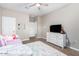 Bright bedroom with ceiling fan, a plush bed, dresser, and TV at 203 S 190Th Ave, Buckeye, AZ 85326