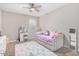 Cozy bedroom with ceiling fan, a daybed, vanity, and a plush rug at 203 S 190Th Ave, Buckeye, AZ 85326