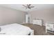Neutral bedroom featuring a ceiling fan, off-white dresser, and a crib in a carpeted space at 203 S 190Th Ave, Buckeye, AZ 85326