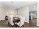 Dining area featuring wood-look flooring, seating for six, and modern decor at 203 S 190Th Ave, Buckeye, AZ 85326