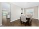 Dining area with wood floors, modern table and seating for six people at 203 S 190Th Ave, Buckeye, AZ 85326