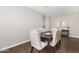 Dining room with dark wood table and upholstered chairs, and wood look flooring at 203 S 190Th Ave, Buckeye, AZ 85326