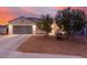 Inviting home exterior at twilight, featuring low-maintenance landscaping and a two-car garage at 203 S 190Th Ave, Buckeye, AZ 85326