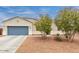Attractive single-story home with a two-car garage and desert landscaping with flowering trees at 203 S 190Th Ave, Buckeye, AZ 85326