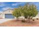 Attractive single-story home with a two-car garage and desert landscaping with flowering trees at 203 S 190Th Ave, Buckeye, AZ 85326