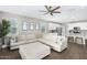 Cozy living room space featuring wood floors, view of the kitchen, and natural lighting at 203 S 190Th Ave, Buckeye, AZ 85326