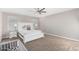 Spacious main bedroom with ceiling fan and adjacent crib, offering comfortable living at 203 S 190Th Ave, Buckeye, AZ 85326