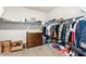 Neatly organized walk-in closet with shelves, hanging clothes, drawers, and shoe storage at 203 S 190Th Ave, Buckeye, AZ 85326