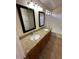 Double sink bathroom featuring granite countertops and framed mirrors at 21192 N 80Th Ln, Peoria, AZ 85382