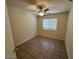 Well-lit bedroom featuring a ceiling fan, tiled flooring, and a window providing ample natural light at 21192 N 80Th Ln, Peoria, AZ 85382