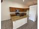 Bright kitchen features granite counters, wood cabinets, and a central island with a sink at 21192 N 80Th Ln, Peoria, AZ 85382