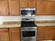 This kitchen includes stainless steel appliances, a gas range, and granite countertops at 21192 N 80Th Ln, Peoria, AZ 85382