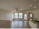 Bright living room featuring tiled floors, lots of windows and a ceiling fan at 21192 N 80Th Ln, Peoria, AZ 85382