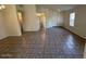 Open living room area with neutral tile flooring, offering a versatile space for living and entertaining at 21192 N 80Th Ln, Peoria, AZ 85382