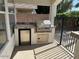 Outdoor built in kitchen with stainless steel grill and mini fridge at 21192 N 80Th Ln, Peoria, AZ 85382