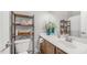 Clean bathroom with wooden cabinet, white countertop, and decorative flowers at 2150 W Alameda Rd # 1424, Phoenix, AZ 85085