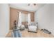 Bedroom with workout equipment, gray accent chair and neutral colored carpet at 2150 W Alameda Rd # 1424, Phoenix, AZ 85085