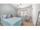 Cozy bedroom with light blue walls, plush carpet, and comfortable furnishings at 2150 W Alameda Rd # 1424, Phoenix, AZ 85085