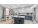 Modern kitchen with white cabinets, blue island, stainless steel appliances, and backyard access at 2150 W Alameda Rd # 1424, Phoenix, AZ 85085