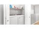 Functional laundry room with washer and dryer, with overhead shelving for storage at 2150 W Alameda Rd # 1424, Phoenix, AZ 85085