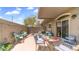 Outdoor patio with comfortable seating, decorative table, string lights, and a privacy wall, ideal for relaxation at 2150 W Alameda Rd # 1424, Phoenix, AZ 85085