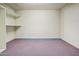 Unfinished basement with shelves, carpet flooring and bright lighting, ready for renovation at 225 S Pioneer -- # 36, Mesa, AZ 85204