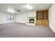Finished basement featuring a fireplace, built-in shelves, carpet, and ample room to entertain at 225 S Pioneer -- # 36, Mesa, AZ 85204