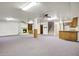 Expansive basement featuring a cozy fireplace, built-in shelving, and neutral carpeting at 225 S Pioneer -- # 36, Mesa, AZ 85204