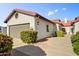 Charming single-story home showcasing a well-maintained yard, red tile roof and stucco facade at 225 S Pioneer -- # 36, Mesa, AZ 85204
