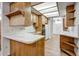 Spacious kitchen featuring tile countertops, wood cabinets, and modern appliances at 225 S Pioneer -- # 36, Mesa, AZ 85204