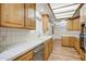 Well-lit kitchen featuring white countertops and light wood cabinets, with stainless steel dishwasher at 225 S Pioneer -- # 36, Mesa, AZ 85204