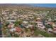 Stunning aerial perspective of a community featuring tile roofs, verdant landscaping, and nearby mountains at 23240 N Country Club Trl, Scottsdale, AZ 85255