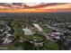 Panoramic aerial view of the golf course community at dusk with water features and lush greenery at 23240 N Country Club Trl, Scottsdale, AZ 85255