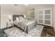 Cozy bedroom features grey slate tile floor, built-in desk and storage, and sliding closet doors at 23240 N Country Club Trl, Scottsdale, AZ 85255