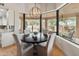 Breakfast nook with seating next to expansive windows looking out on the pool and backyard at 23240 N Country Club Trl, Scottsdale, AZ 85255