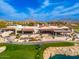 Aerial view of the Clubhouse with outdoor seating, golf course, and lakeside views at 23240 N Country Club Trl, Scottsdale, AZ 85255