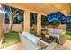 Comfortable seating on a covered patio area that overlooks the expansive artificial turf at 23240 N Country Club Trl, Scottsdale, AZ 85255